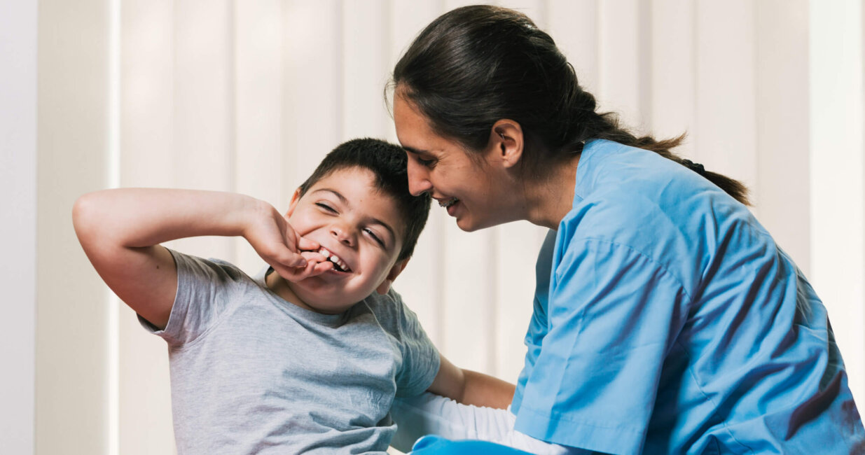 Child with clinician in scrubs