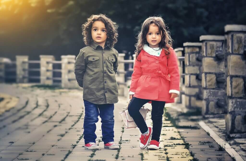 Two children standing on bridge
